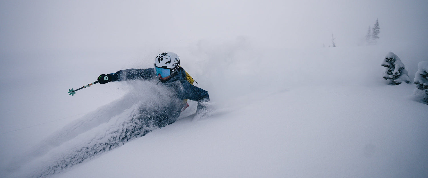 A skier charges through deep snow