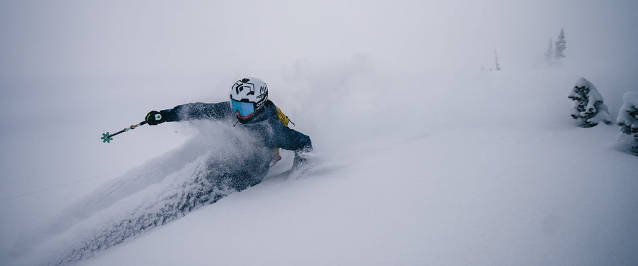 A skier charges through deep snow