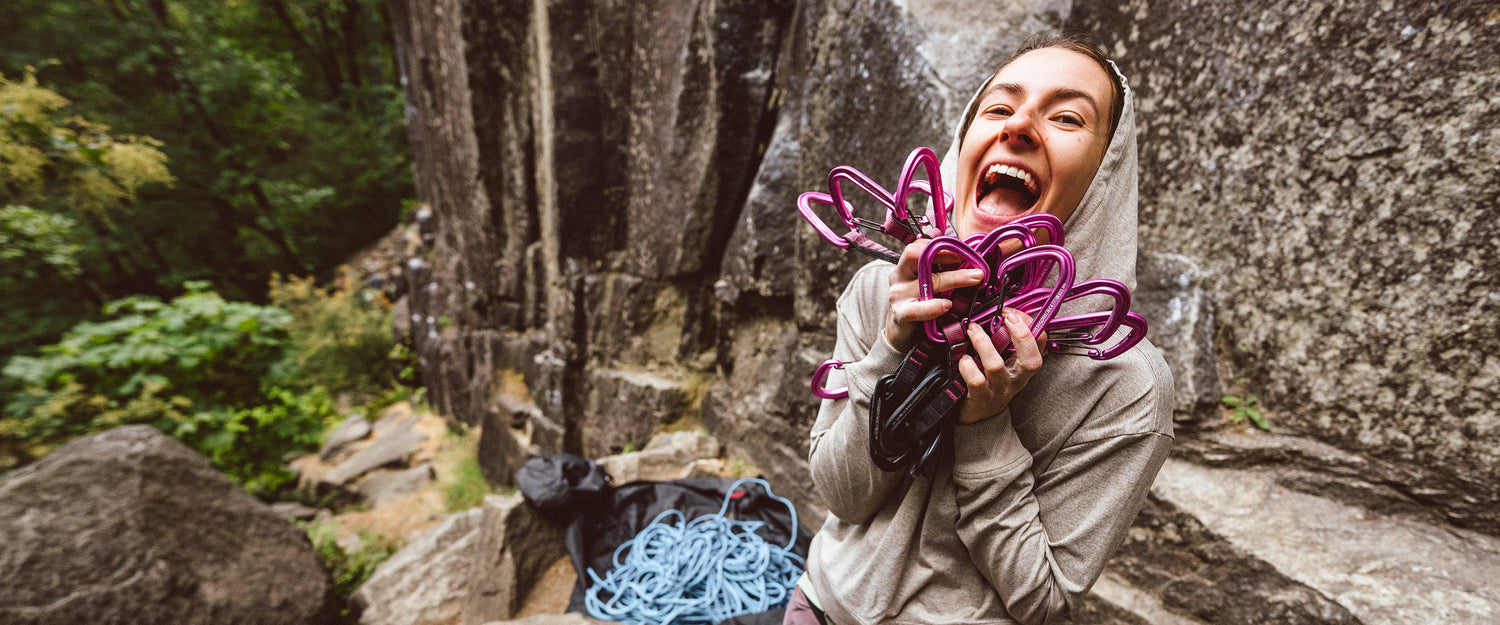 A climber proudly displays her hotforge quickdraws